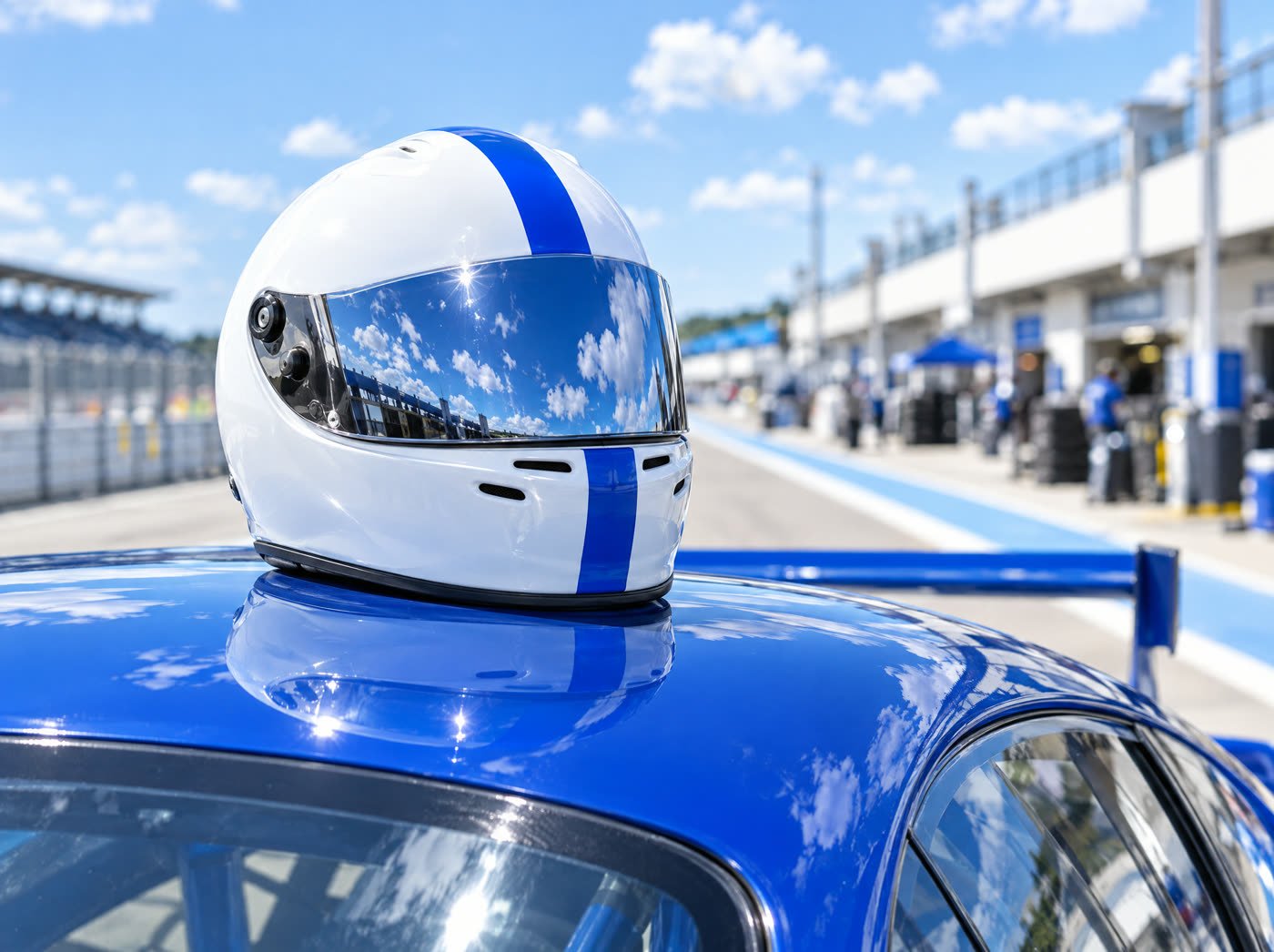 Jordan's white and blue helmet resting on the roof of the car in pit lane